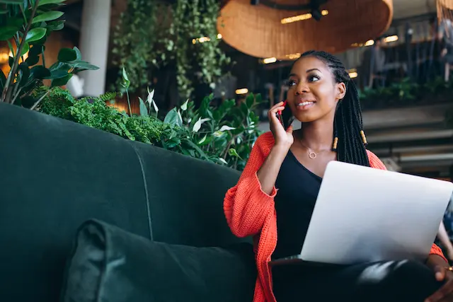 african-american-woman-with-phone-laptop-cafe-1