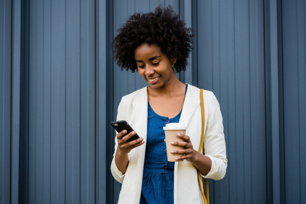 Business woman using her mobile phone outdoors.