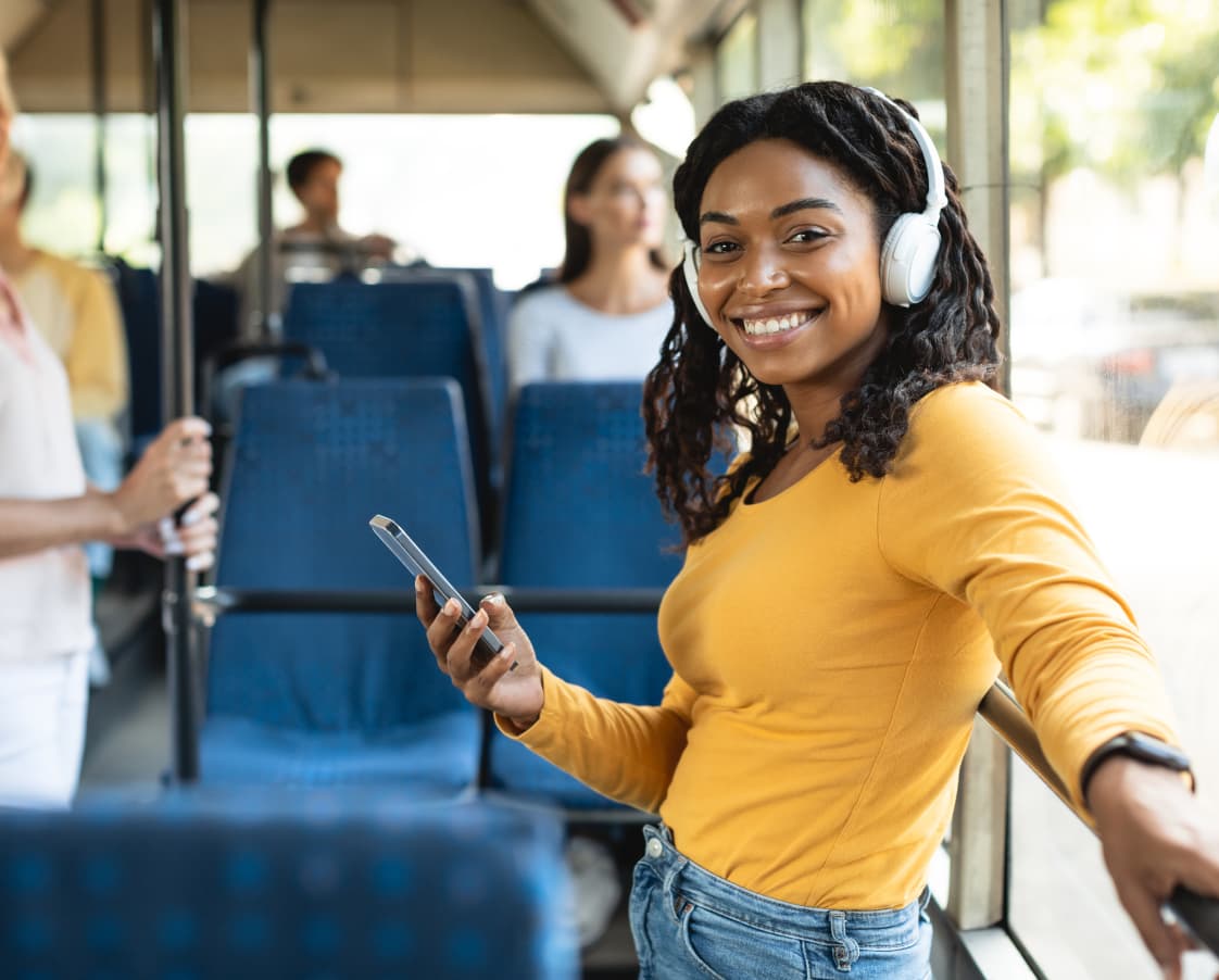 cheerful-black-lady-using-smartphone-wearing-headp-2022-12-16-08-07-37-utc