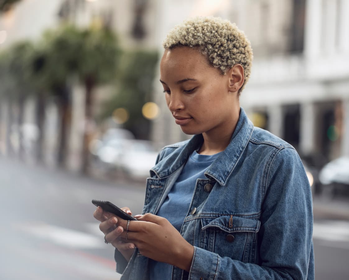 young-woman-using-smartphone-in-the-city-2022-12-16-22-43-17-utc